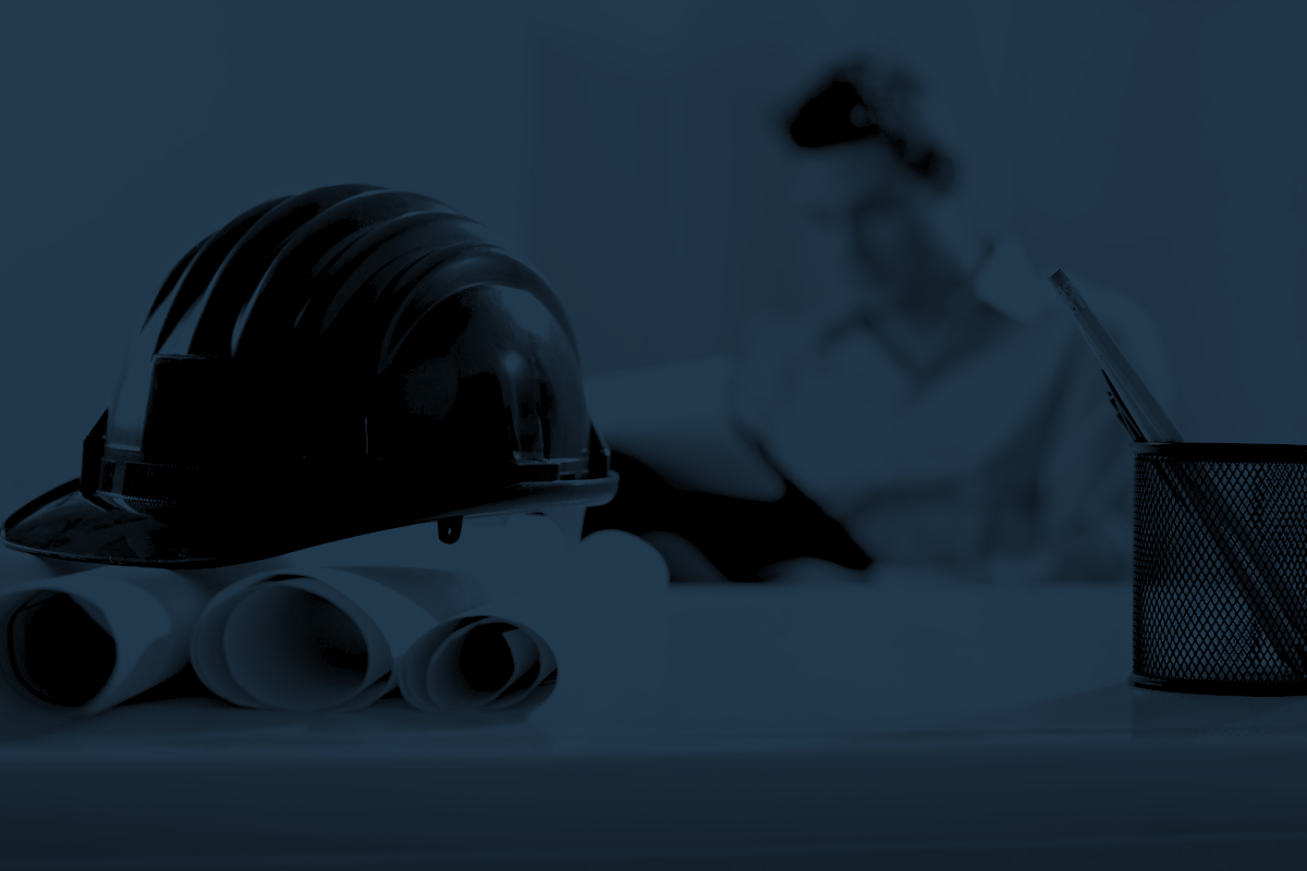 Capacete e pranchas de projeto sobre a mesa do escritório